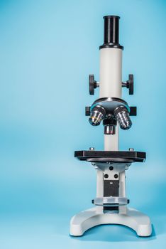 science microscope on light blue background