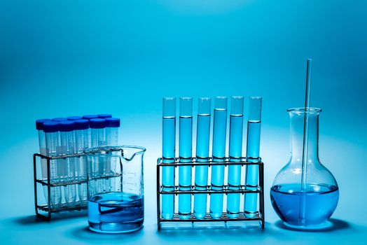 science laboratory test tubes on light blue background , laboratory equipment