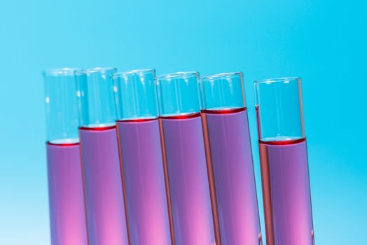 science laboratory test tubes on light blue background , laboratory equipment