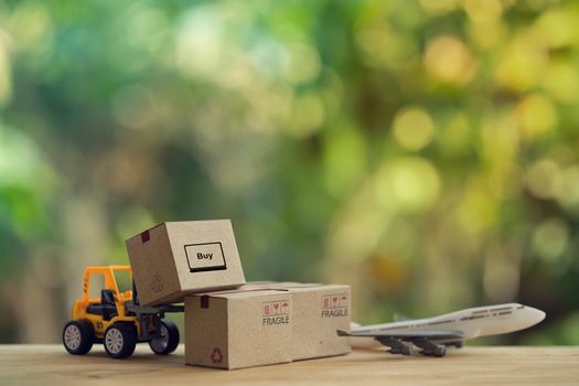 Logistic and cargo freight concept: Fork-lift truck moves a pallet with Paper boxes, plane. depicts delivery management from the point of origin to point of consumption according to needs of customers