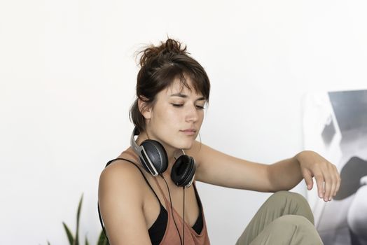 Young freelancer woman stretching at home workplace