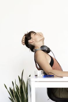 Young freelancer woman stretching at home workplace