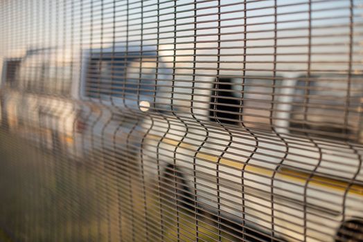 Taxis parked behind chainlink fence