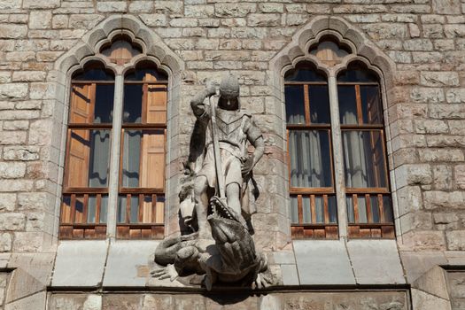 Leon, Spain - 9 December 2019: Saint George killing dragon statue above the entrance to Casa Botines