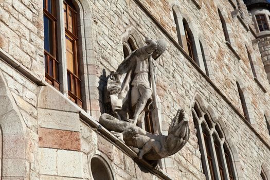 Leon, Spain - 9 December 2019: Saint George killing dragon statue above the entrance to Casa Botines