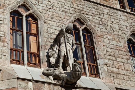 Leon, Spain - 9 December 2019: Saint George killing dragon statue above the entrance to Casa Botines