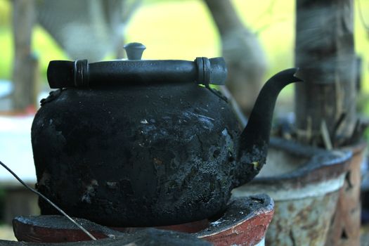 Black kettle, on a strong charcoal stove