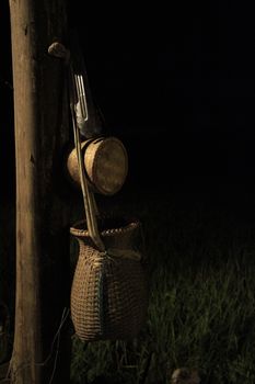 Hanging fish container attached to the house post.