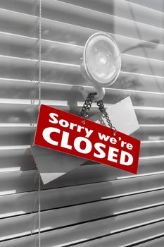Closed Sign on a door with venetian blind