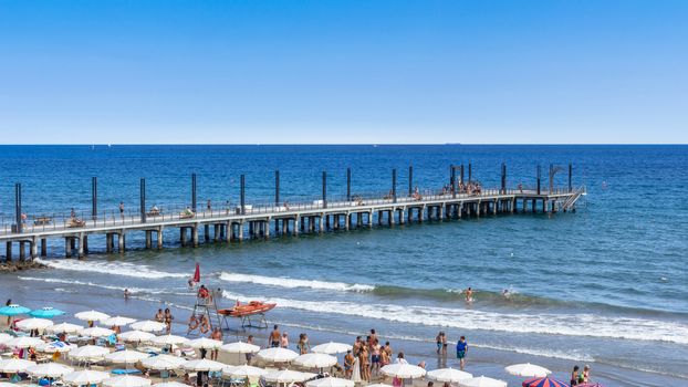 Alassio (SV), ITALY - August 22, 2017: time lapse of people relaxing on crowded beach