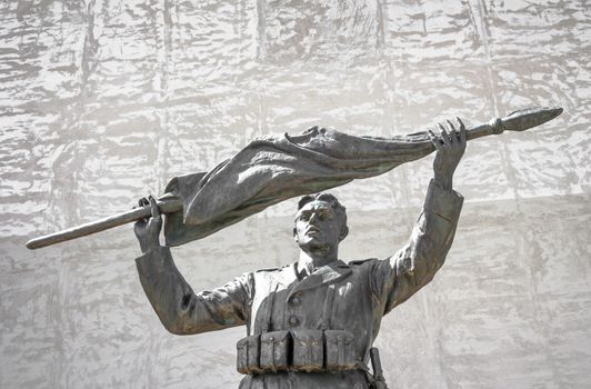 Bronze of an italian soldier statue with rolled up flag