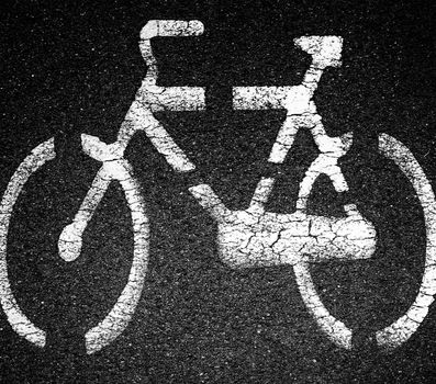White bicycle sign on asphalt bike lane on city street. Concept background for many use.