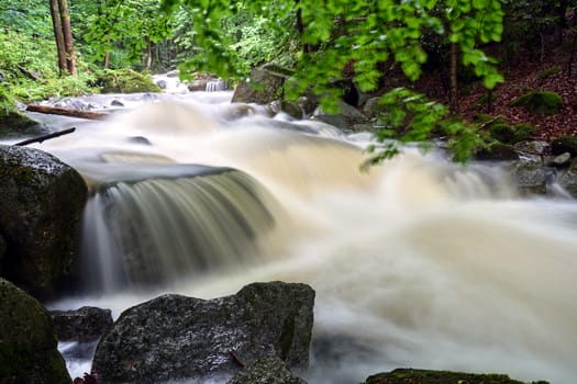 Rocks and boulders in the mountain stream in the forest in the Giant Mountains in Poland