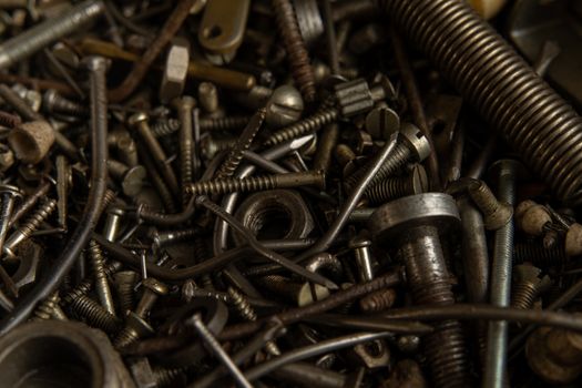 Range Rusty old screws bolts nuts. Grunge metal Hardware details dark nackground
