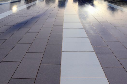 Diffuse reflections of pedestrians walking a marble sidewalk