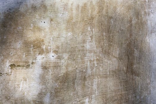 Old whitewashed brown weathered distressed cracked cement stone wall texture background