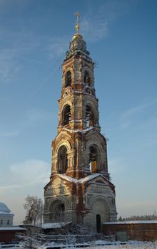 Winter view of the ancient bell tower in the Russian village Avdotieno