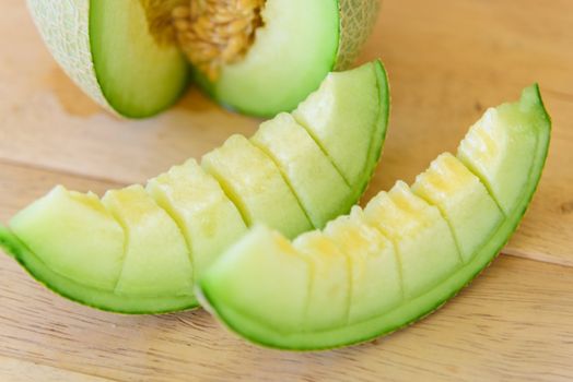 Fresh Green melon on wood plate