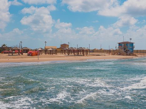 Metsitsim Beach in Tel Aviv city on a sunny day. Wave on the Mediterranean sea. The coast is empty without people because of the quarantine due to the outbreak of the coronavirus 2020 (COVID-19).