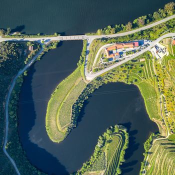 Douro wine valley region drone aerial top view of s shape bend river in Quinta do Tedo at sunset, in Portugal