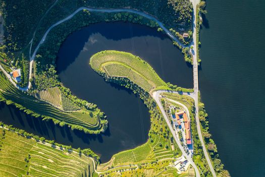 Douro wine valley region drone aerial top view of s shape bend river in Quinta do Tedo at sunset, in Portugal