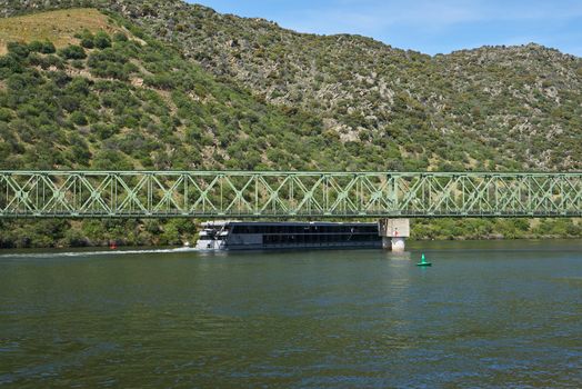 Boats passing on railway bridge in Douro region in Ferradosa, Portugal