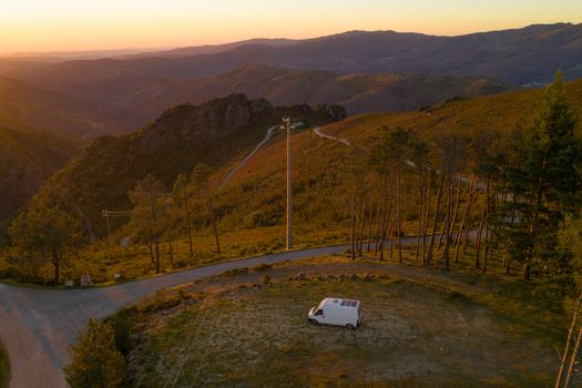 Serra da Freita drone aerial view of a camper van in Arouca Geopark at sunset, in Portugal