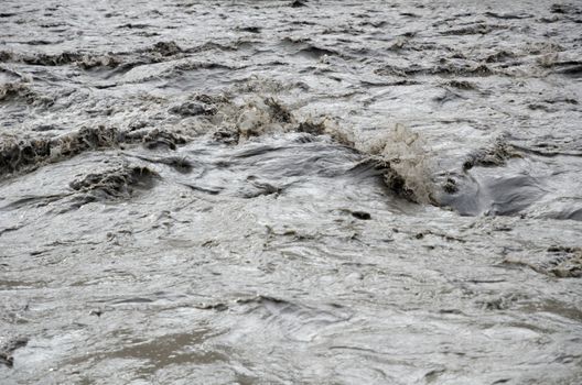 Fast, affluent and muddy mountain Nepal river near Jomsom village