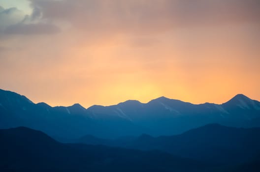 Colorful gradient sunset under the distant Tibetan mountains at Qinghai province