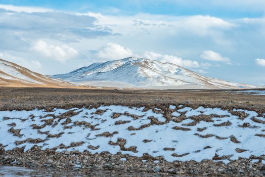 Amazing Tibetan landscape with snowy mountains and cloudy sky at Qinghai province