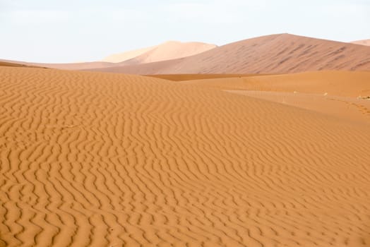 Endless sand waves on a flat sand dune at Namib Desert