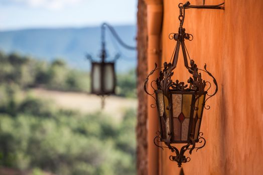 Forged carved lamp on a wall as a metallurgy engineering artwork