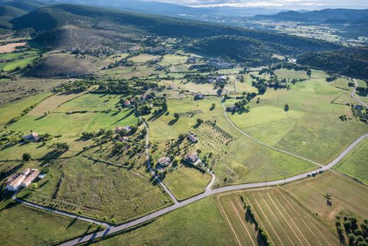 Birds eye view of the cultivated land, roads and private houses of Provence