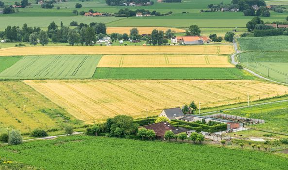 Diksmuide, Flanders, Belgium -  June 19, 2019: View on farms and farm land from up IJzertoren, tallest peace monument of WW 1. Greens, yellows and reds.