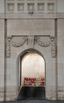 Diksmuide, Flanders, Belgium -  June 19, 2019: Historic Menin Gate. Steps up leading to dispaly of wreaths with red poppies. Beige wall with remembrance declaration.
