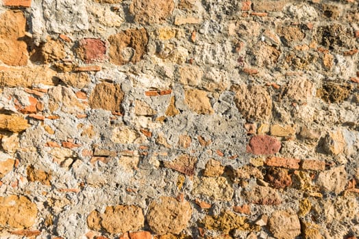 Close up view of an aged textured plastered stone wall