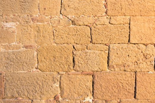 Close up view of an ancient flat textured brick wall