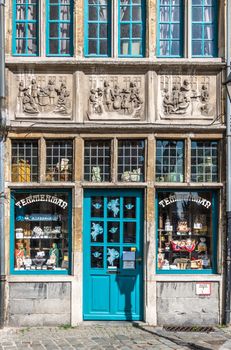 Gent, Flanders, Belgium -  June 21, 2019: Historic small shop on Kraanlei houses Confectioner Temmerman. authentic candy of a previous era. Three of Matthew Works of Mercy sculptures in facade.