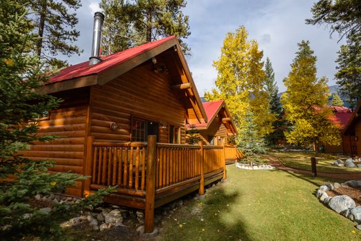 Comfortable quiet wooden hotel at the multicolored fall forest of Banff National Park