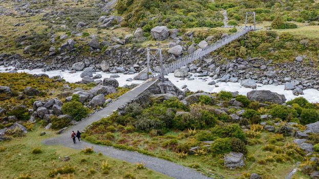 Hanging bridge across highland river at Hooker Valley Track, Mount Cook National Park, New Zealand