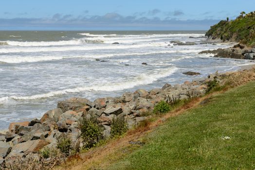 Big waves and huge boulders on the Pacific Ocean coast near the Kaka Point, New Zealand