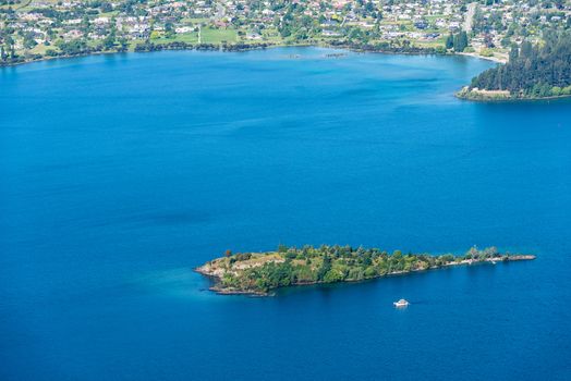 Amazing view of a luxury yacht and turquoise water of Wanaka Lake, New Zealand