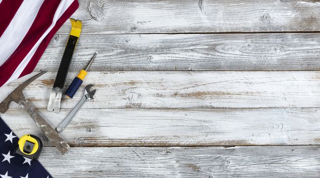 US Happy Labor Day concept with national flag and work tools on white rustic wooden background 