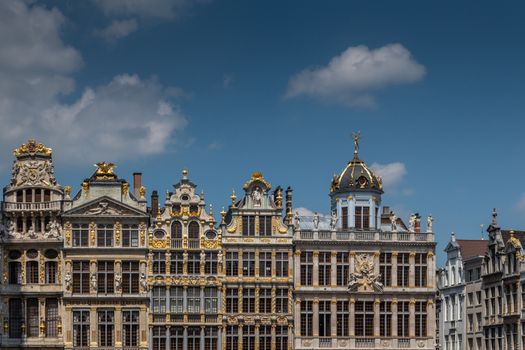 Brussels, Belgium - June 22, 2019: Beige stone facades and gables with statues on top at northwest side of grand Place.