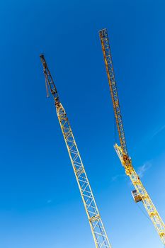 Boom crane on a background of blue sky.