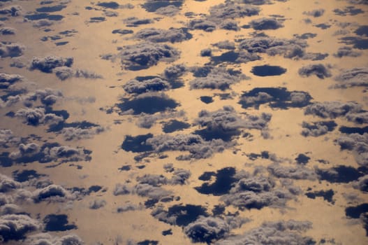 Close aerial view of the cumulus clouds over Red Sea in direct sunlight