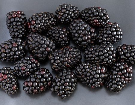 Blackberries close-up. Grey background.