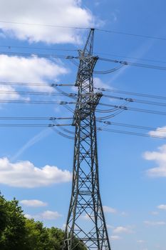 Close up view on a big power pylon transporting electricity in a countryside area in Europe