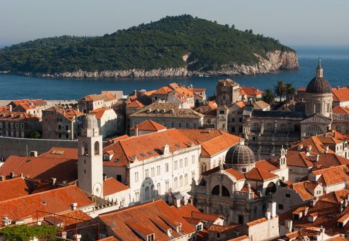 This is a close picture of Dubrovnik red and orange roofs and distant island behind.