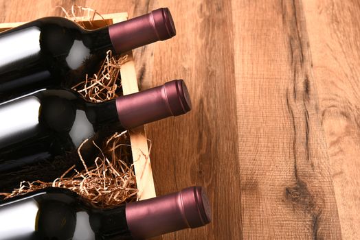 High angle view of a crate of wine bottles on a wood table with copy space.